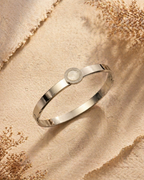 MM Jewelry: Sleek Silver Bangle with Mother-of-Pearl Centerpiece